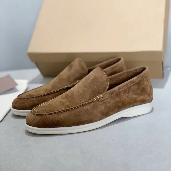 Side view of caramel tan suede loafers with white sole and tonal stitching on toe