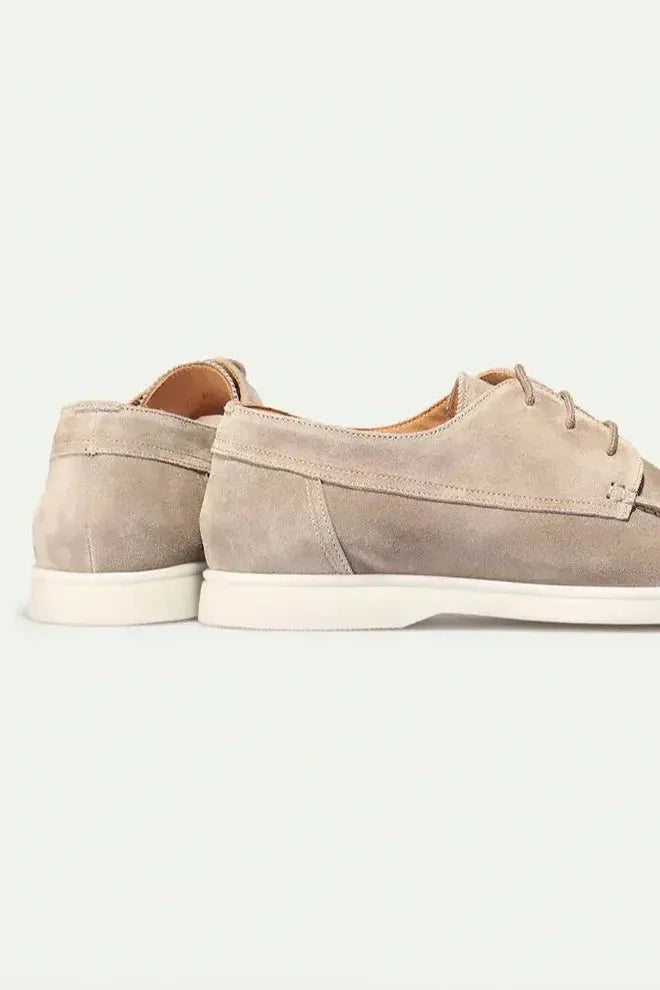 Back and side view of beige suede lace-up shoes showing heel seam and cream outsole