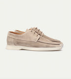 Side profile of beige suede lace-up shoes with a moc-toe seam and cream rubber sole