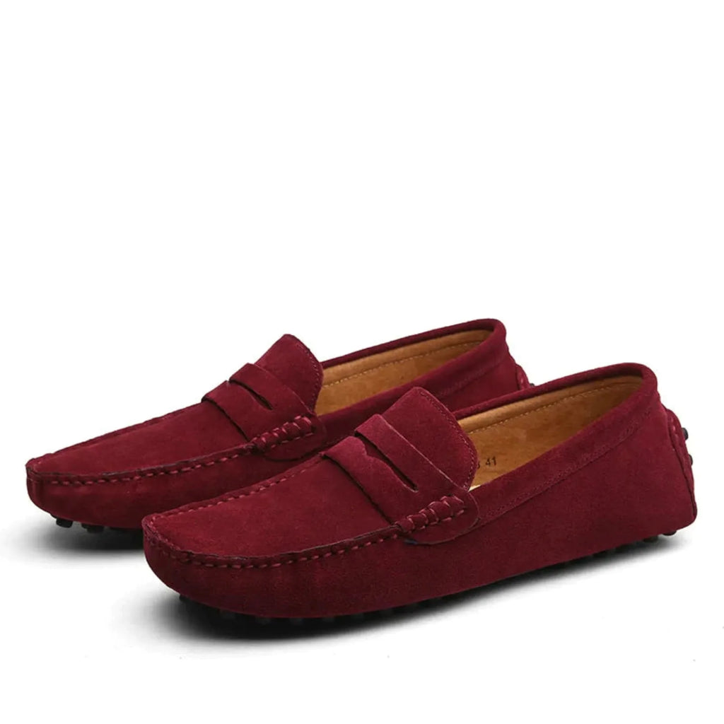 Close view of red suede loafer sole showing the textured rubber driving pegs