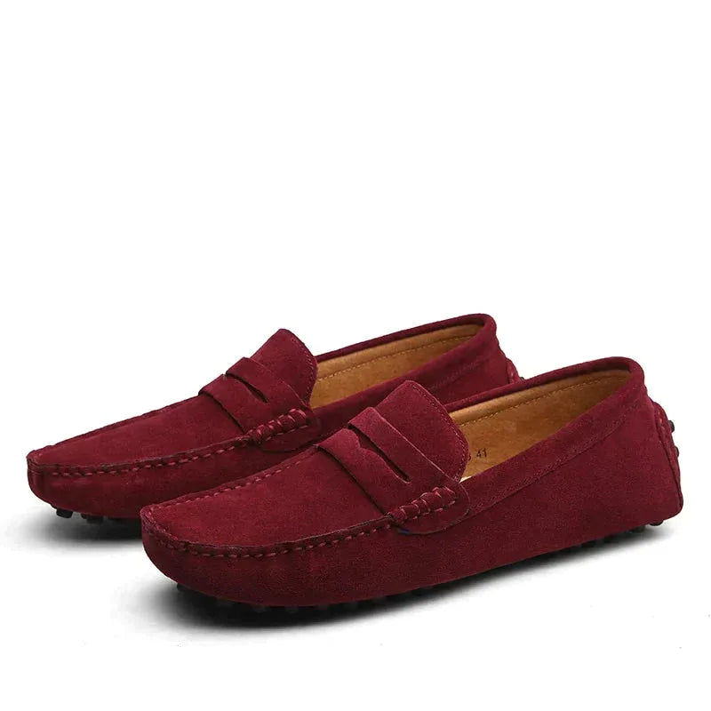 Deep red suede driving loafers with classic penny strap detail and stitched moccasin toe