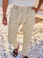 Khaki beige linen-blend pants shown from the waist down with drawstring tie and relaxed tapered fit
