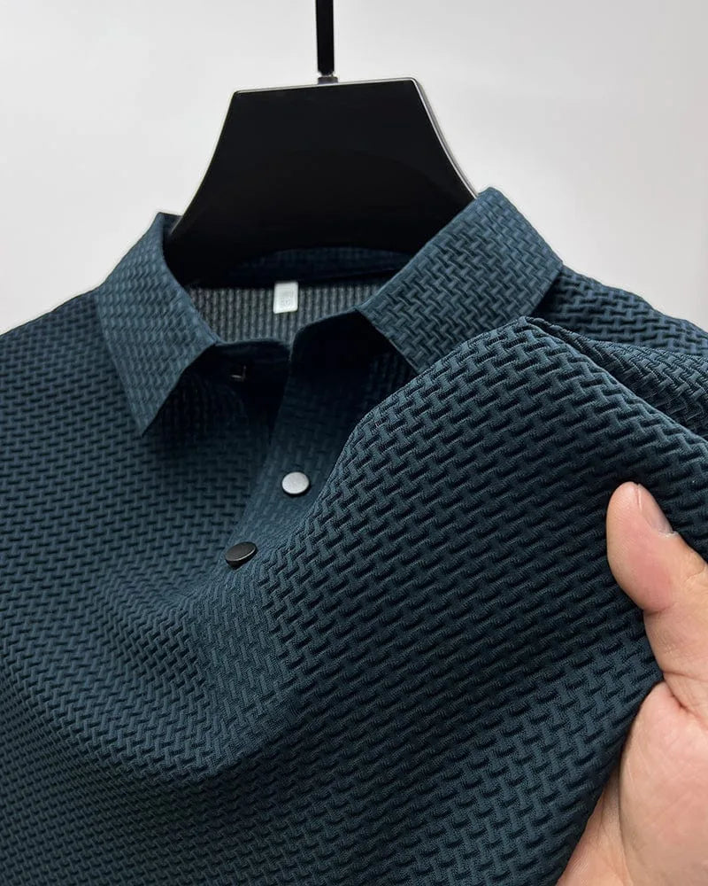 Navy blue textured polo shirt detail, showing woven collar and two-button placket with silver and black buttons