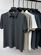 Six textured polo shirts in grey, beige, white, dark green and navy hanging together on a rail, front view