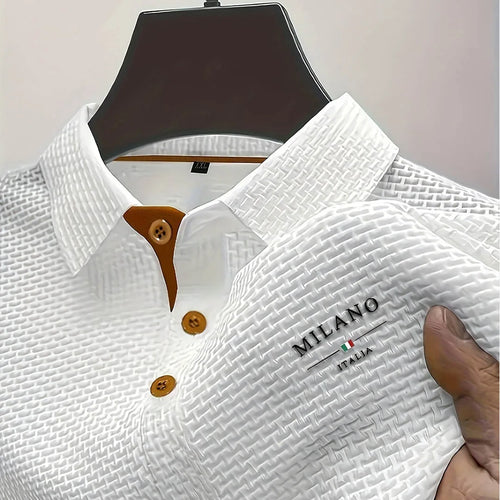 White textured polo shirt displayed on hanger with hand holding fabric to show basketweave texture