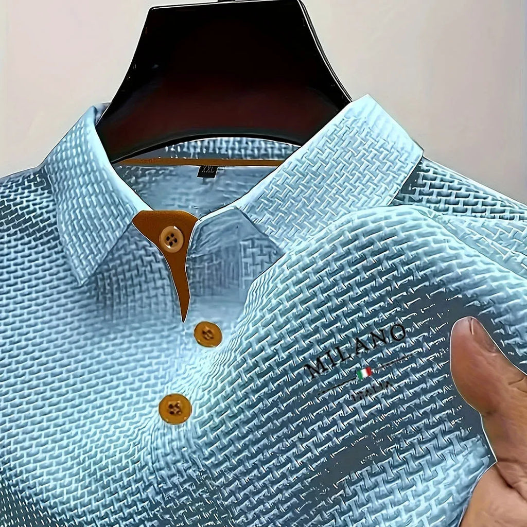 Light blue textured polo shirt on mannequin with contrast tan buttons and embroidered chest logo