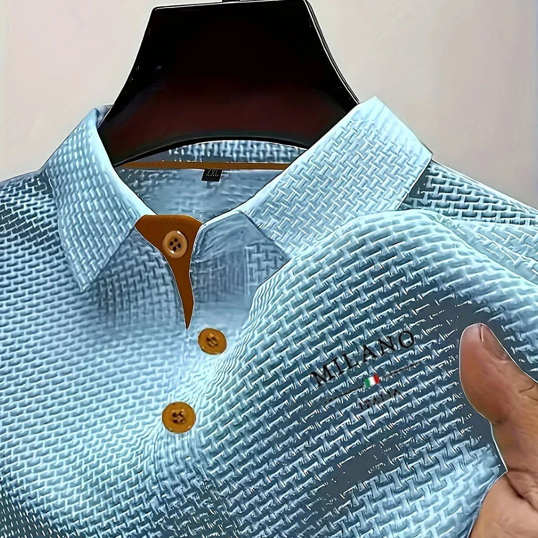 Light blue textured polo shirt on mannequin with contrast tan buttons and embroidered chest logo