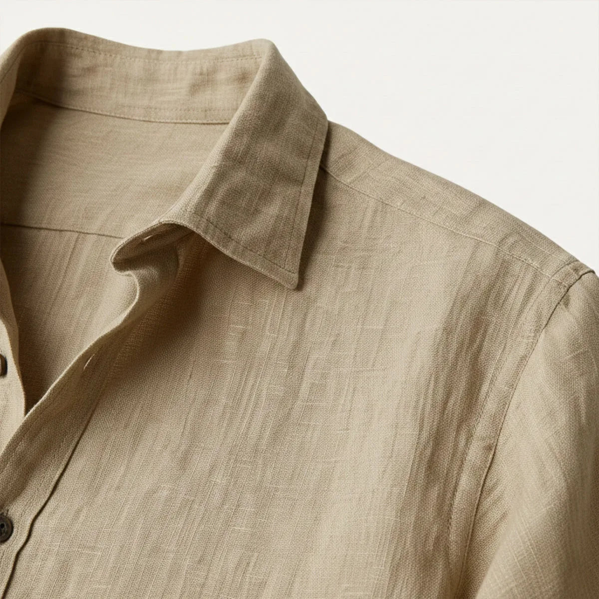 Close-up of khaki linen collar and shoulder seam showing the textured woven fabric