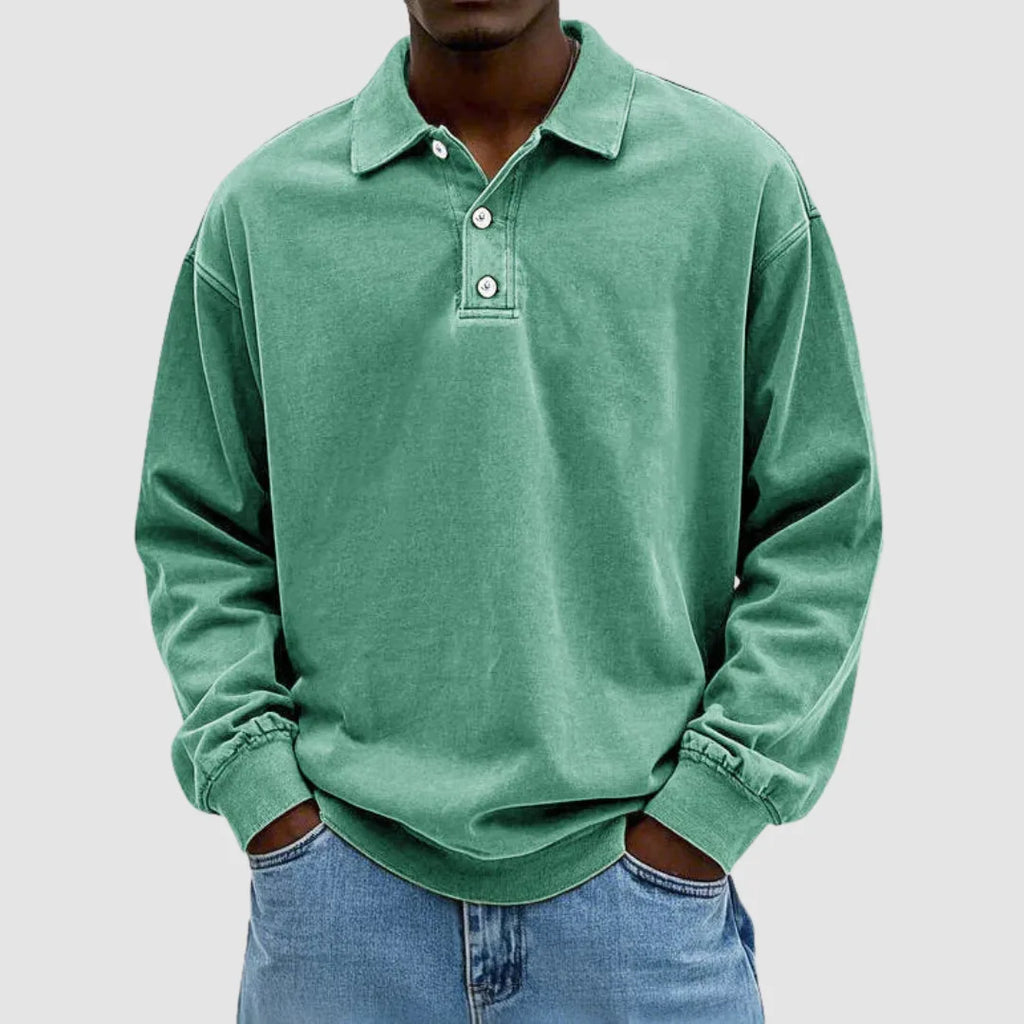 Green washed long-sleeve polo jumper with collared neckline and button placket, styled with light denim jeans