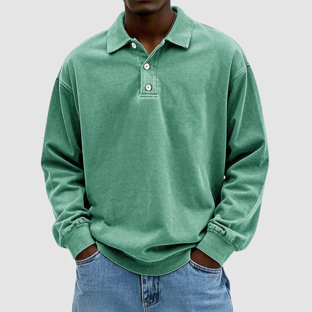 Green washed long-sleeve polo jumper with collared neckline and button placket, styled with light denim jeans