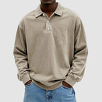 Khaki long-sleeve polo top with relaxed oversized fit and visible stitched seam detail across the chest