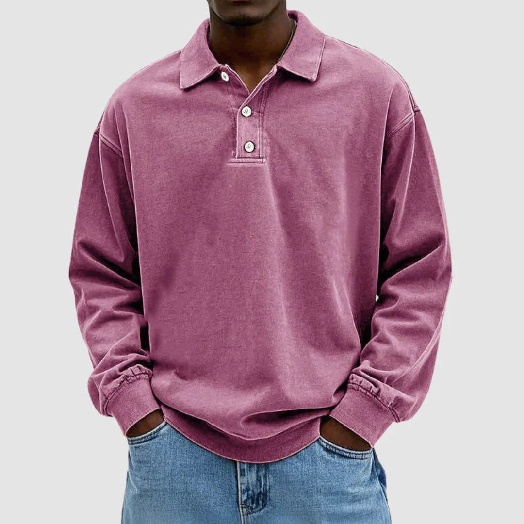 Dusty pink washed long-sleeve polo shirt with classic collar and two-button front, worn with blue jeans