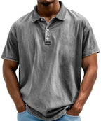 Grey washed polo shirt with three-button placket shown on model, relaxed fit through the body