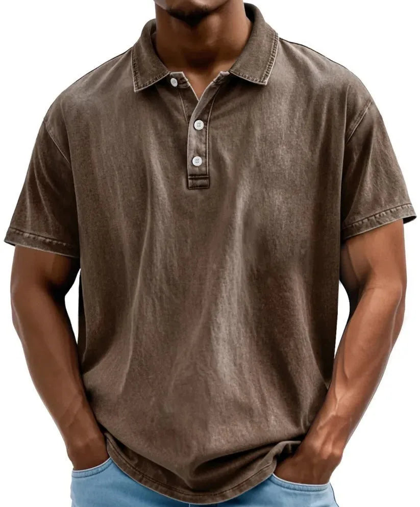 Brown vintage-wash polo shirt with collar and short sleeves, worn untucked over denim shorts