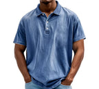 Mid-blue denim-look polo shirt with faded wash and button placket, close front view on model
