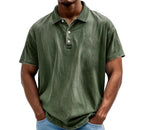 Dark green washed polo shirt with button placket, worn by model with hands in pockets