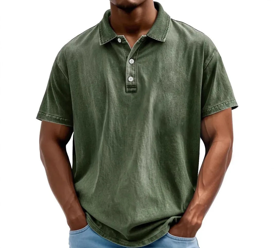 Dark green washed polo shirt with button placket, worn by model with hands in pockets