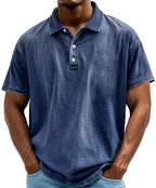 Dark blue washed polo shirt with collar and button placket, close-up front view on model