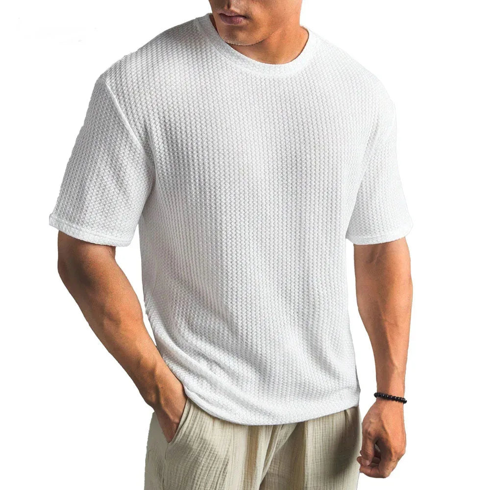 Man wearing a white waffle-knit short-sleeve t-shirt with a classic crew neck, front view, relaxed fit