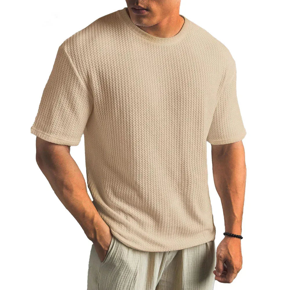 Khaki waffle-textured short-sleeve t-shirt on a male model, showing the ribbed fabric detail and crew neckline