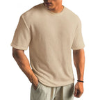 Khaki waffle-textured short-sleeve t-shirt on a male model, showing the ribbed fabric detail and crew neckline