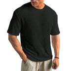 Black waffle-knit crew neck t-shirt, front-on view highlighting the raised textured weave across the chest