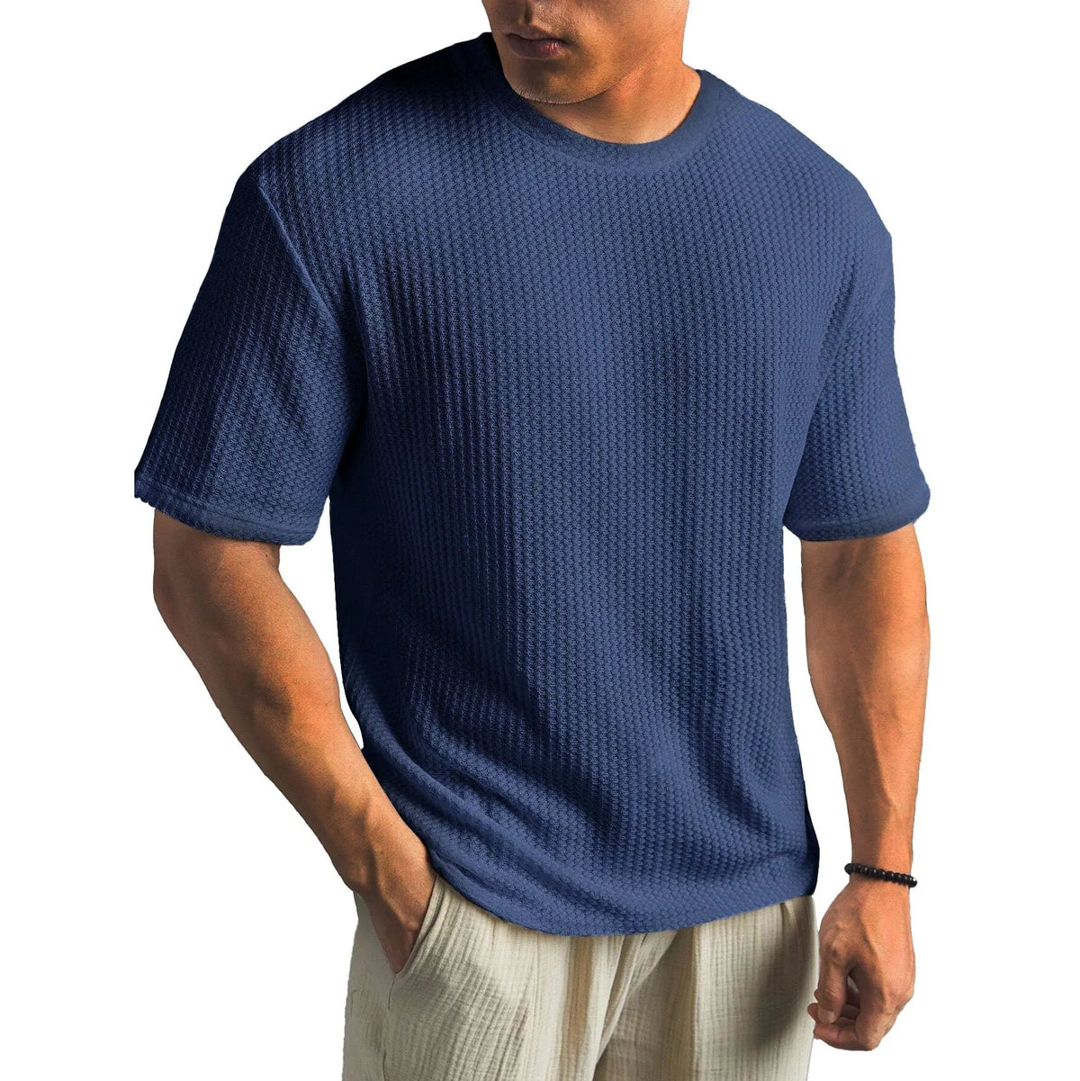 Slate blue textured short-sleeve t-shirt on a male model, showing the relaxed drape and ribbed cuffs