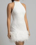 Close-up of the beaded sequin texture across the bodice and the high halter neckline of the mini dress