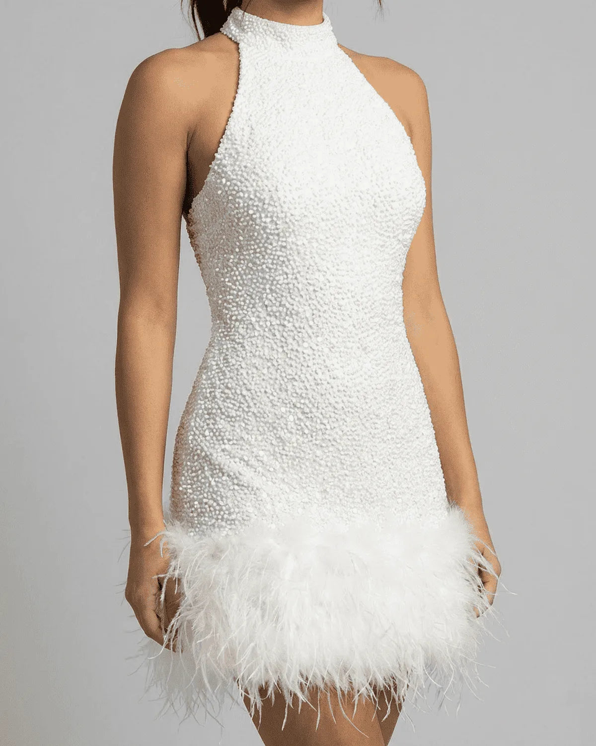 Close-up of the beaded sequin texture across the bodice and the high halter neckline of the mini dress