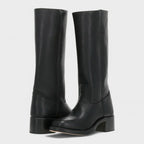 Front pair of knee-high black leather boots with pull-on tab and round toe silhouette