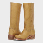 Mustard yellow leather boots with contrast topstitching and visible brand stamp on shaft
