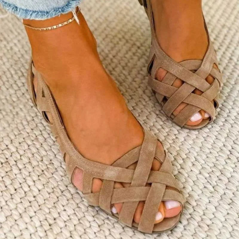 Top-down view of taupe cross-strap suede sandals highlighting the woven peep-toe design
