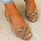 Top-down view of taupe cross-strap suede sandals highlighting the woven peep-toe design