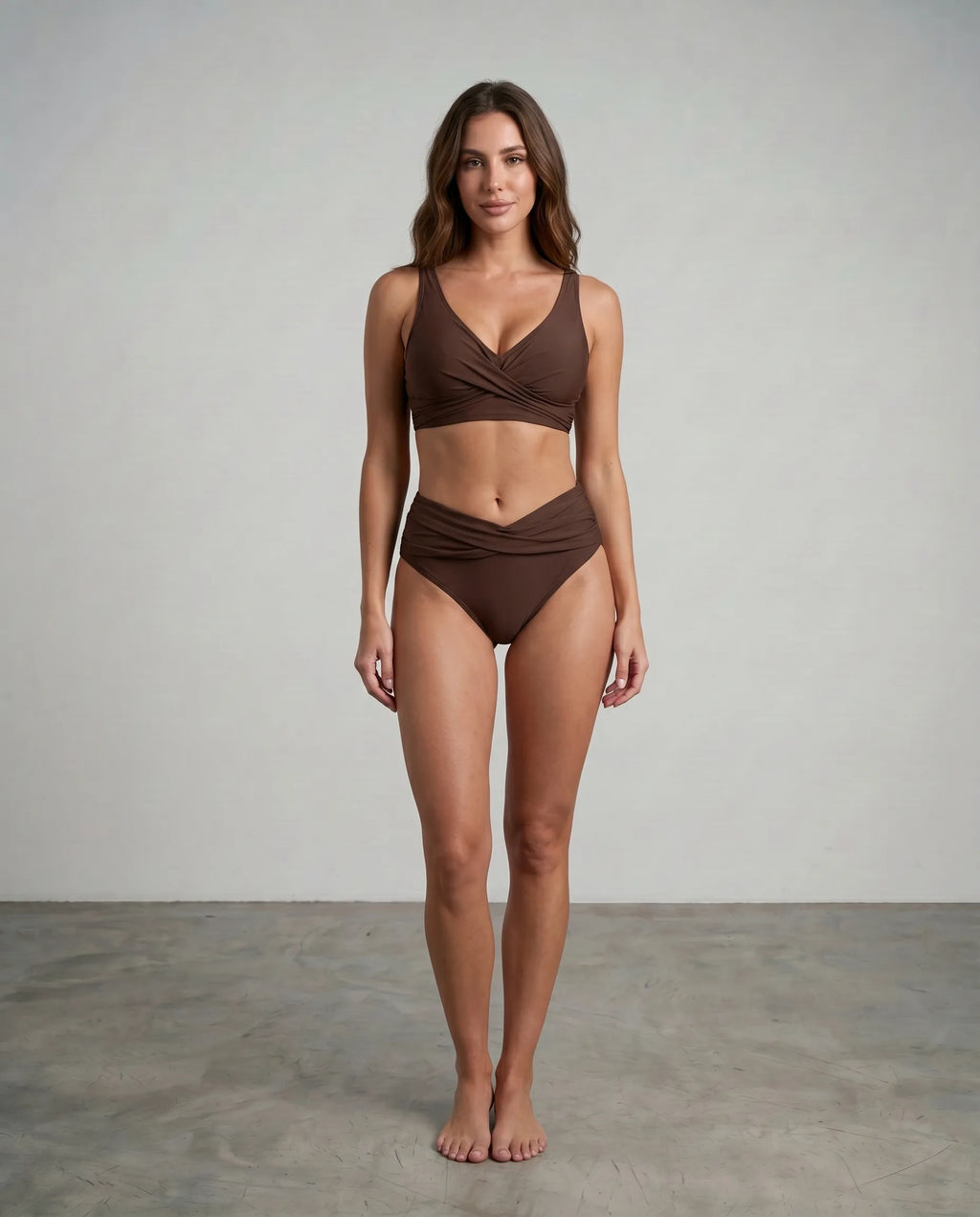 Front view of a brown high-waisted bikini bottom showing the crossover waistband and ruched sides