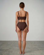 Front view of a woman modelling a brown wrap bikini set, showing the full silhouette from chest to thigh