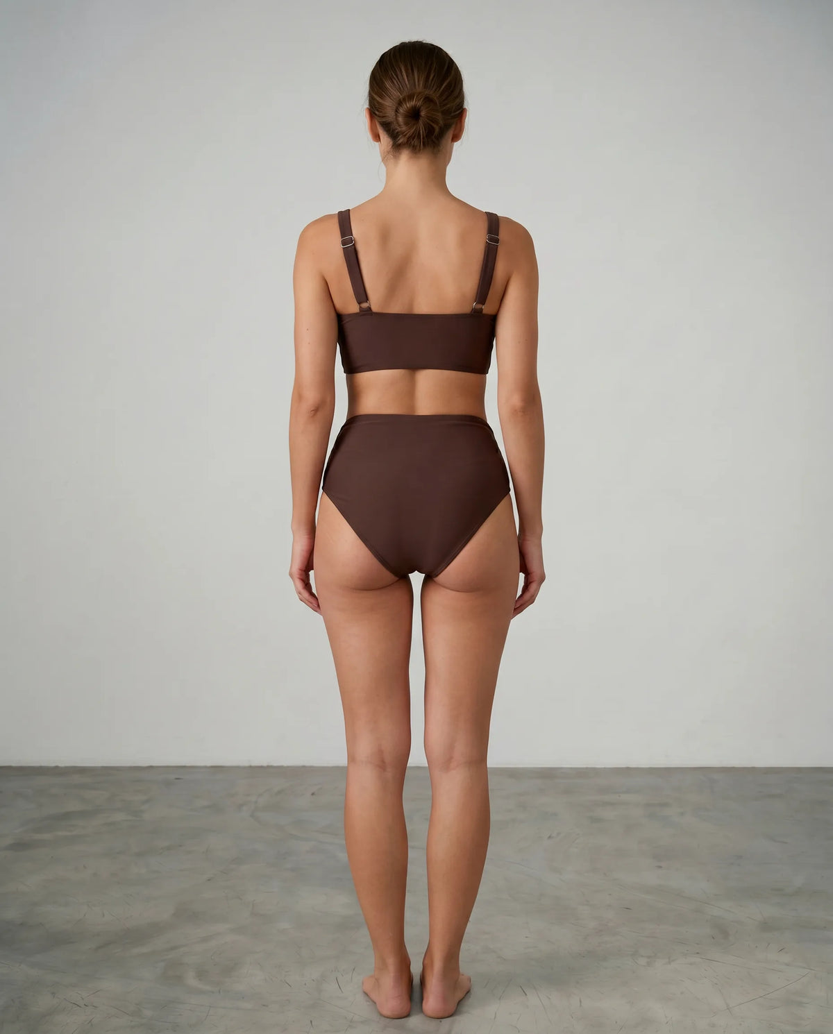 Front view of a woman modelling a brown wrap bikini set, showing the full silhouette from chest to thigh