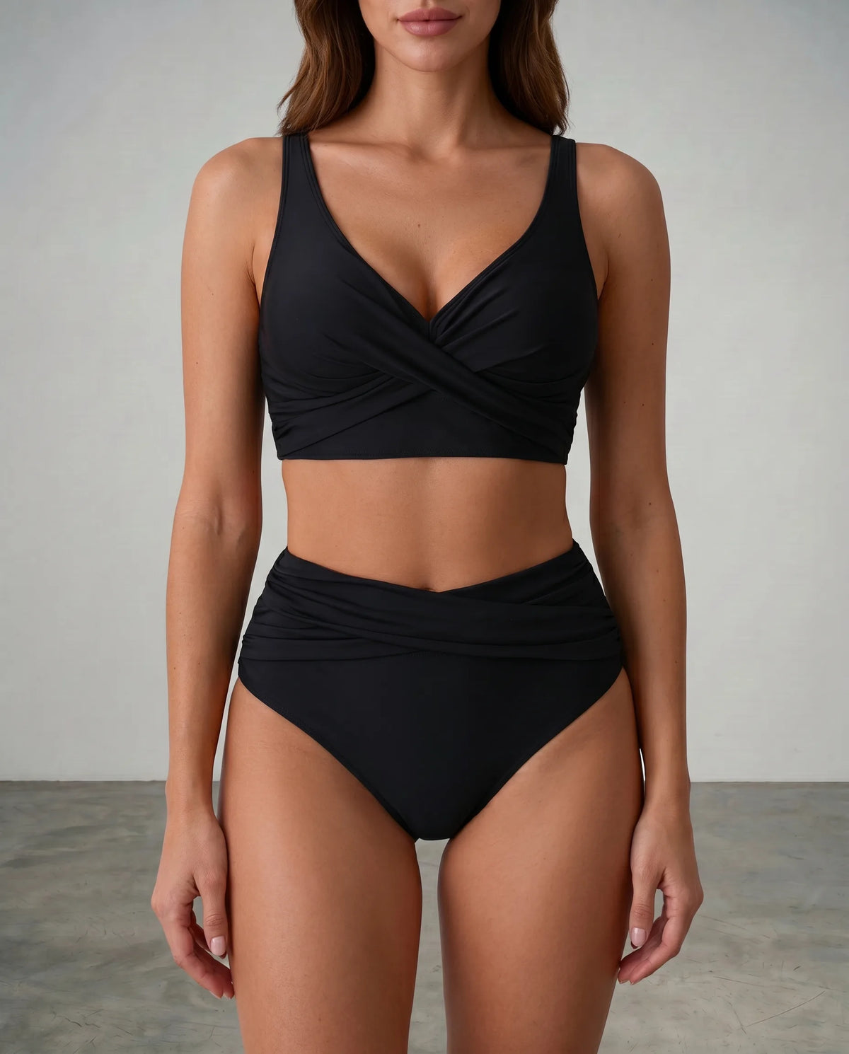 Front view of a black wrap bikini set with twist detailing on the top and high-waisted ruched bottoms
