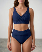 Front view of a navy blue wrap bikini with a V-neck twist top and high-waisted ruched bottoms