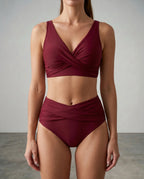 Front view of a burgundy wrap bikini set with twist front top and high-waisted bottoms