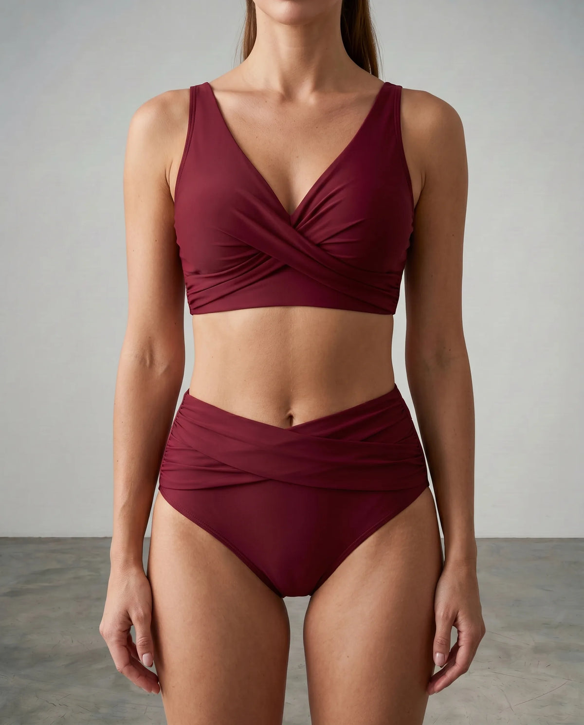Front view of a burgundy wrap bikini set with twist front top and high-waisted bottoms