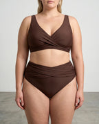 Front view of a plus-size model wearing a brown wrap bikini with twist top and high-waisted ruched bottoms