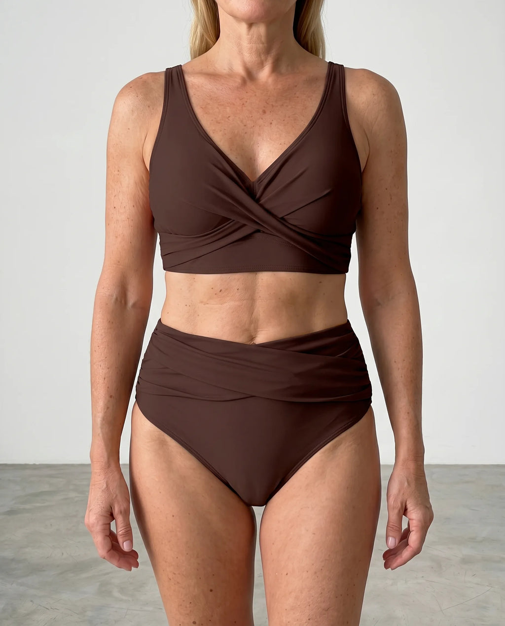 Close-up front view of a brown wrap bikini top highlighting the V-neckline and wide shoulder straps