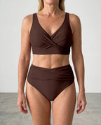 Close-up front view of a brown wrap bikini top highlighting the V-neckline and wide shoulder straps